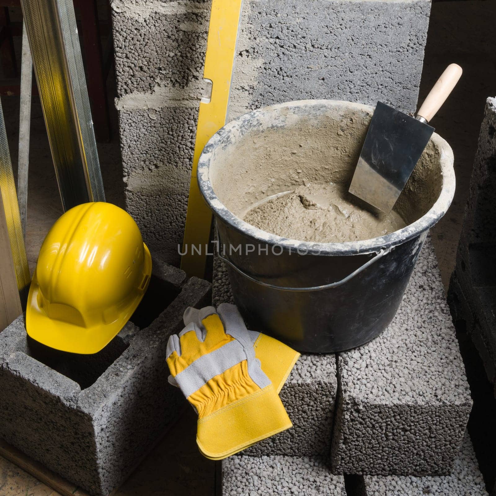 Tools for bricklayer bucket with a solution and a trowel, close-up