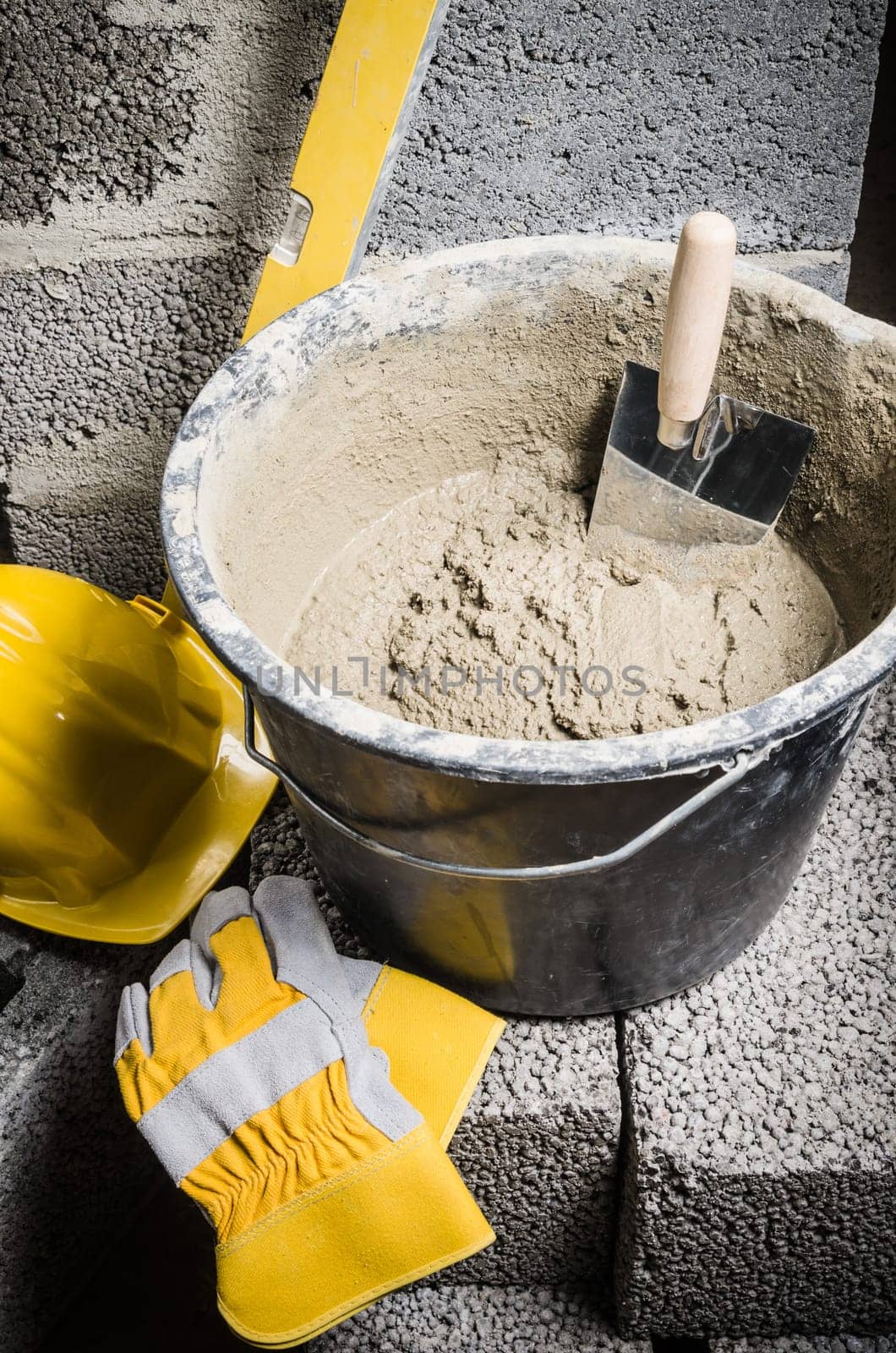 Tools for bricklayer bucket with a solution and a trowel, close-up