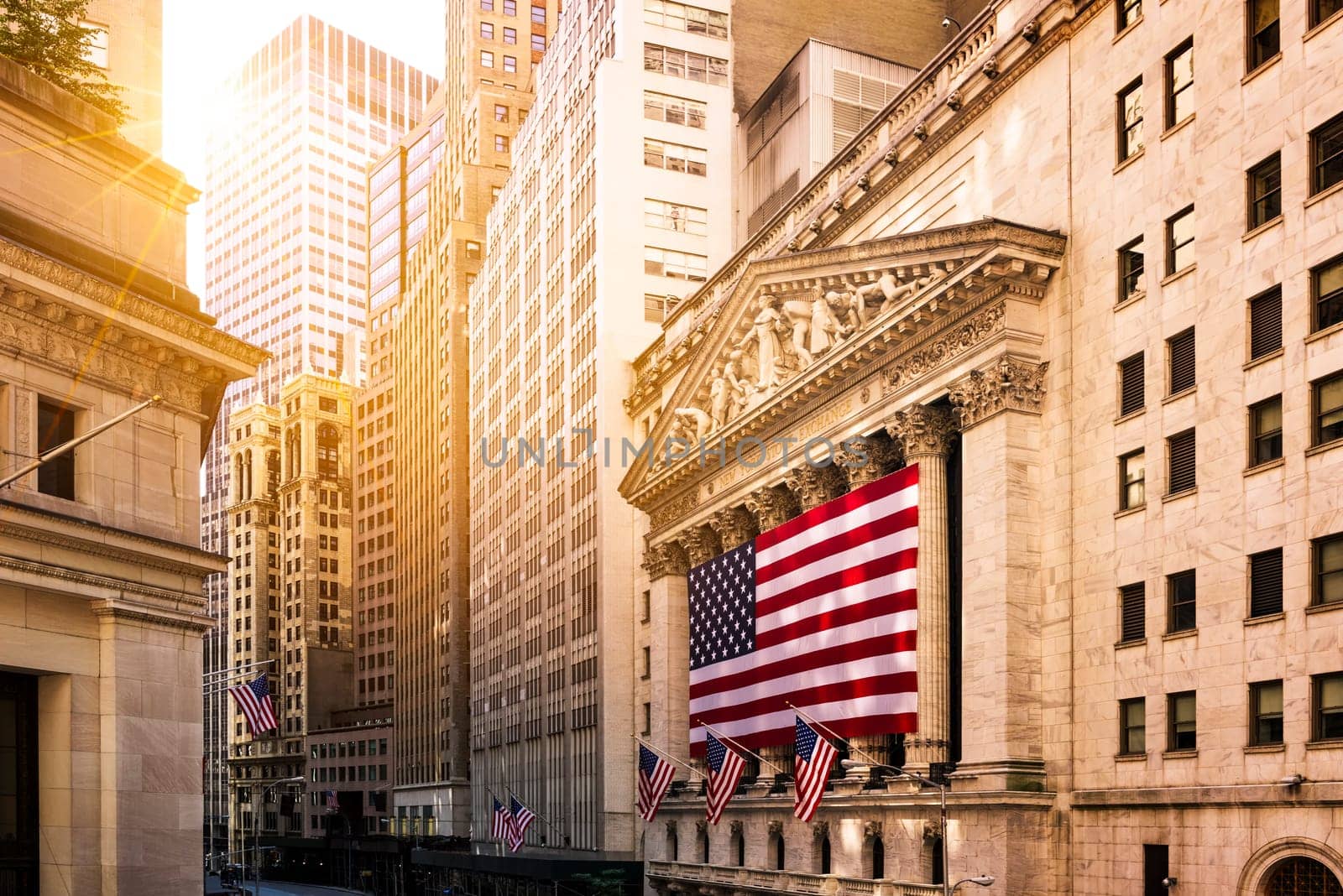 Famous Wall street and the building in New York, New York Stock Exchange with patriot flag