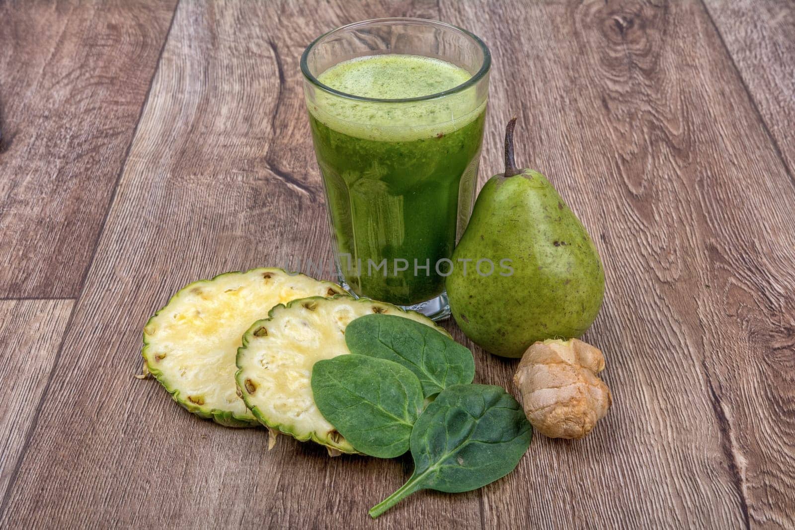 Blended fruit smoothie with ingredients on wooden table