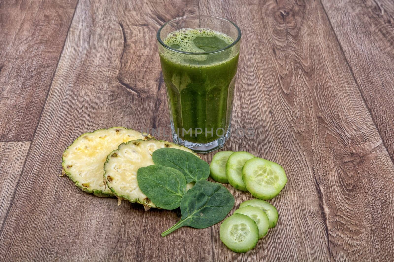 Blended fruit smoothie with ingredients on wooden table