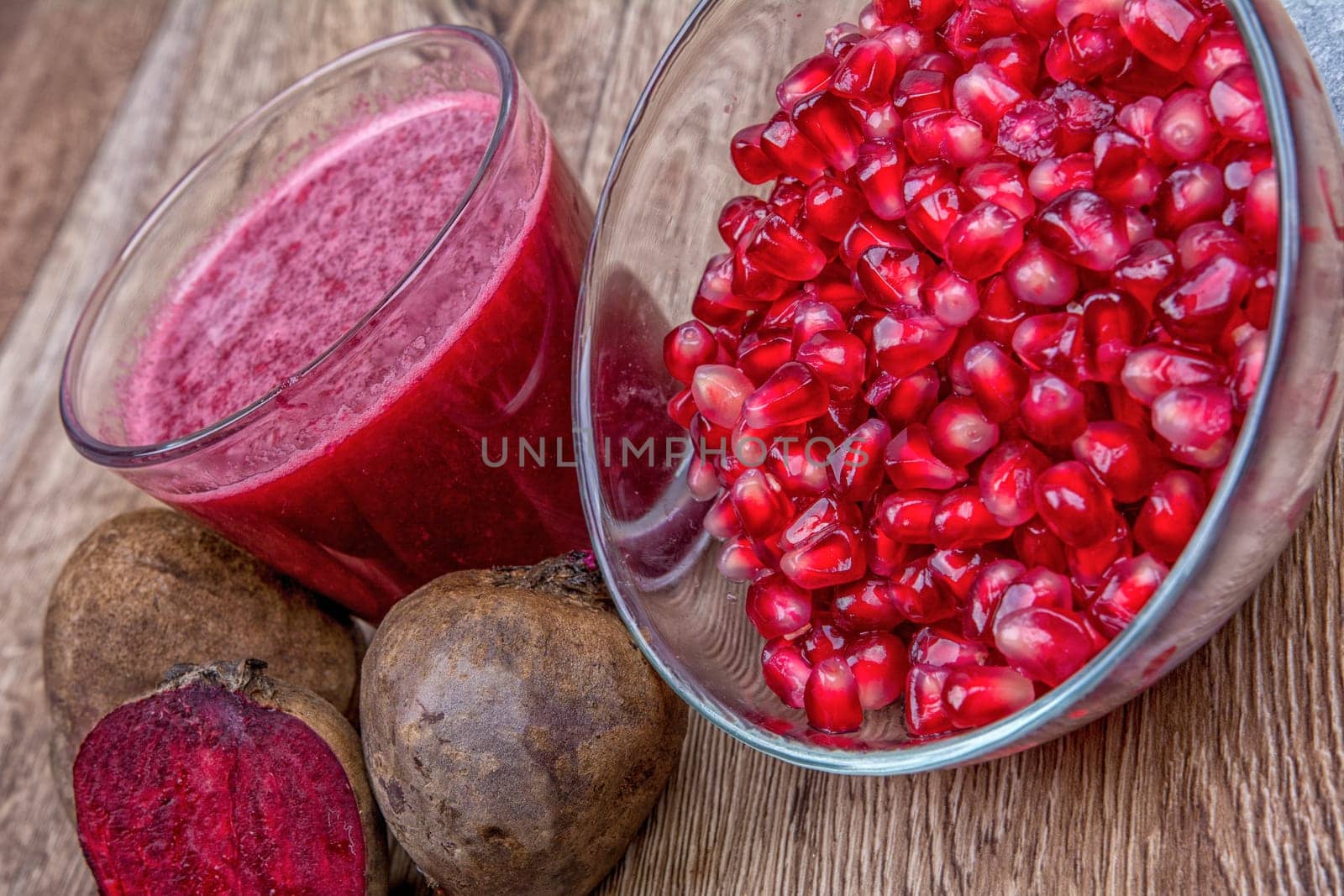 Blended fruit smoothie with ingredients on wooden table