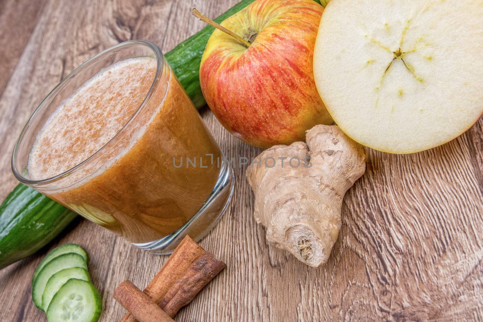 Blended fruit smoothie with ingredients on wooden table