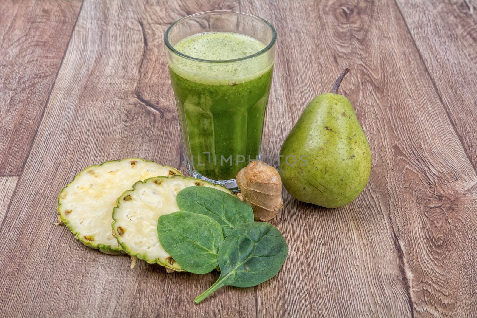 Blended fruit smoothie with ingredients on wooden table