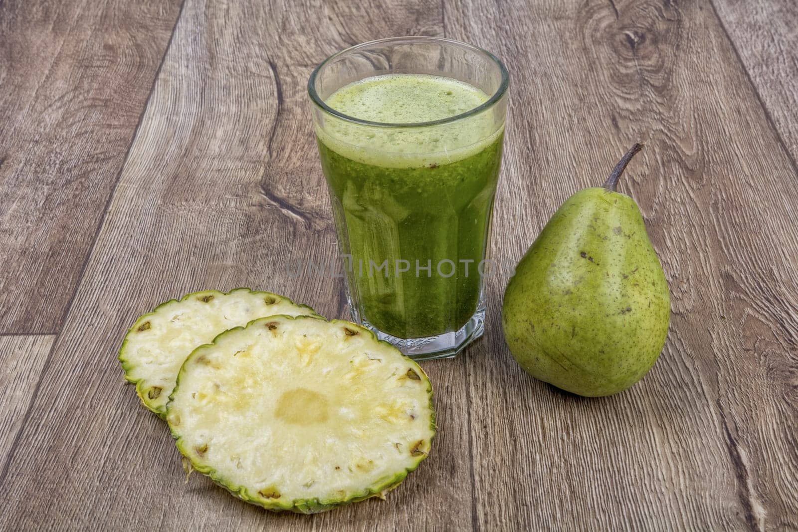 Blended fruit smoothie with ingredients on wooden table