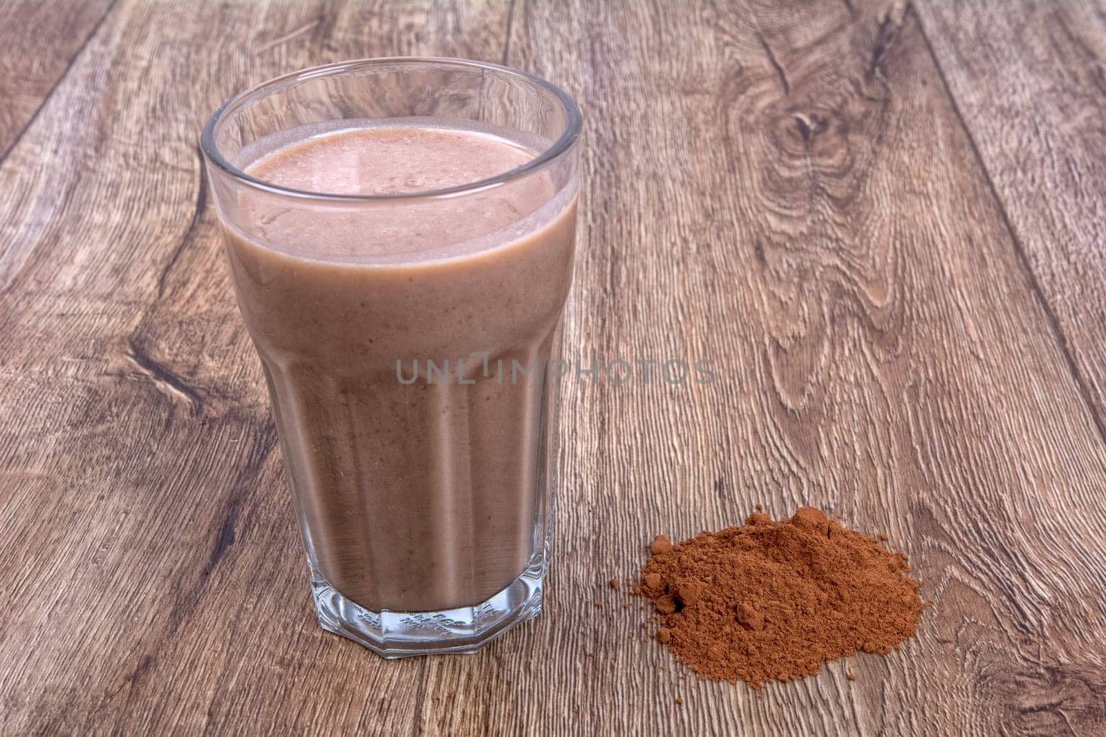 Blended fruit smoothie with ingredients on wooden table