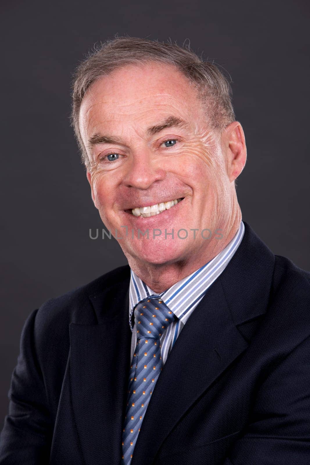 handsome caucasian man wearing business suit on dark background