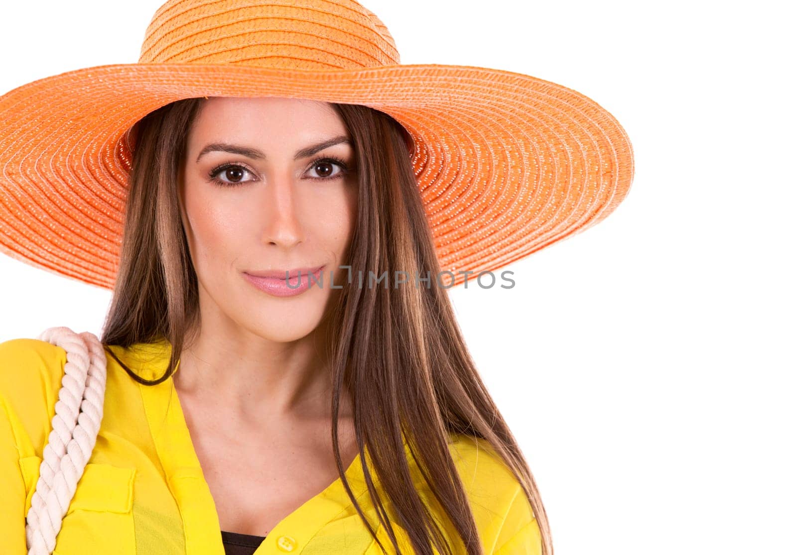 young woman wearing yellow shirt and orange hat on white background