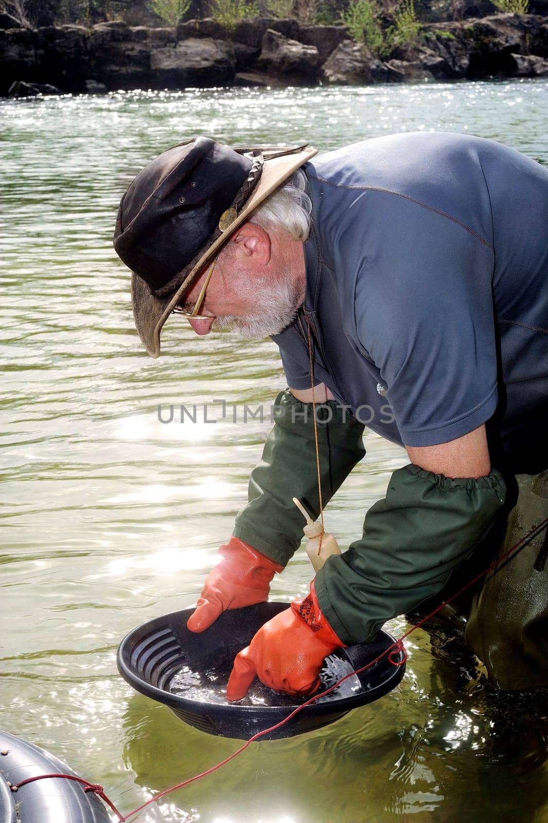 Gold digger in France in the region of Cevennes and the department of Gard in the middle of the river called Le Gardon