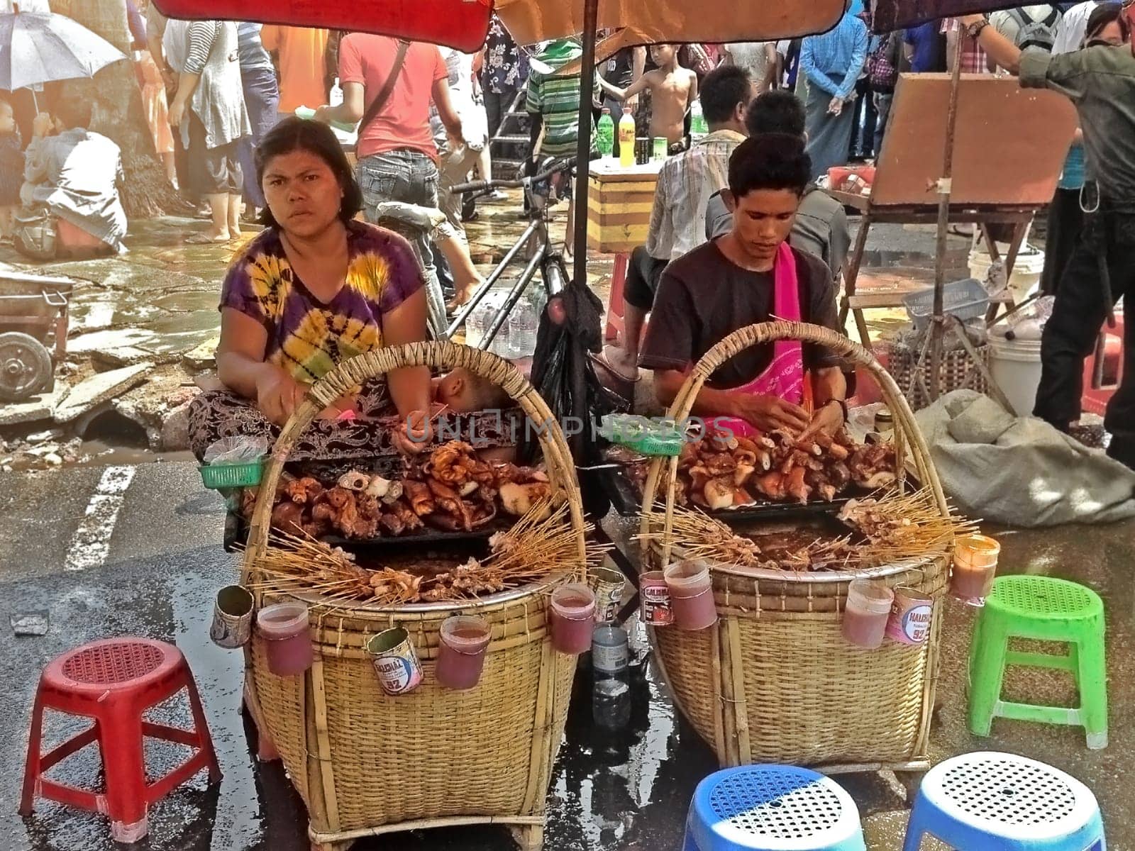 Yangon, Myanmar - Apr 15, 2013. Street food sellers in Yangon, Myanmar. Locals eat pot street food.