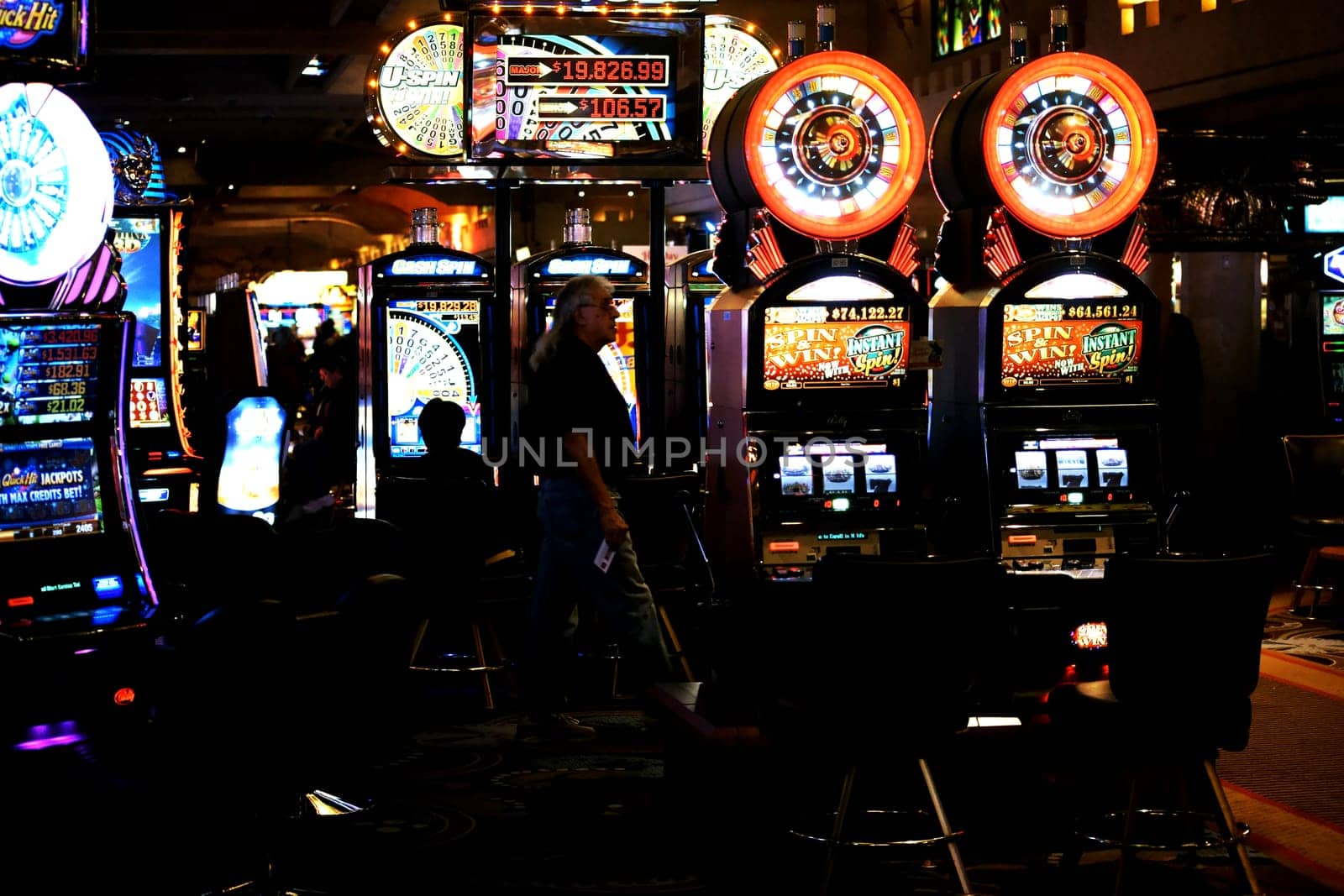 Las Vegas,United States - December 23,2015: Colorful slot machines and visitors in the foyer of Casino Excalibur on the night of December 23,2015 in Las Vegas.