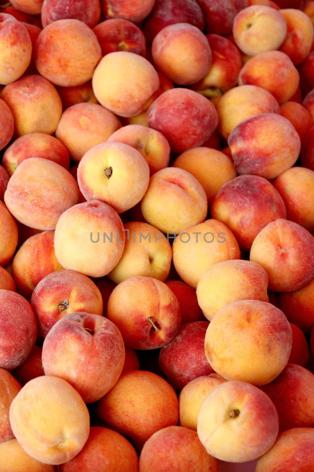 Fresh organic peaches background, photo taken at local farmers market, in New York City.