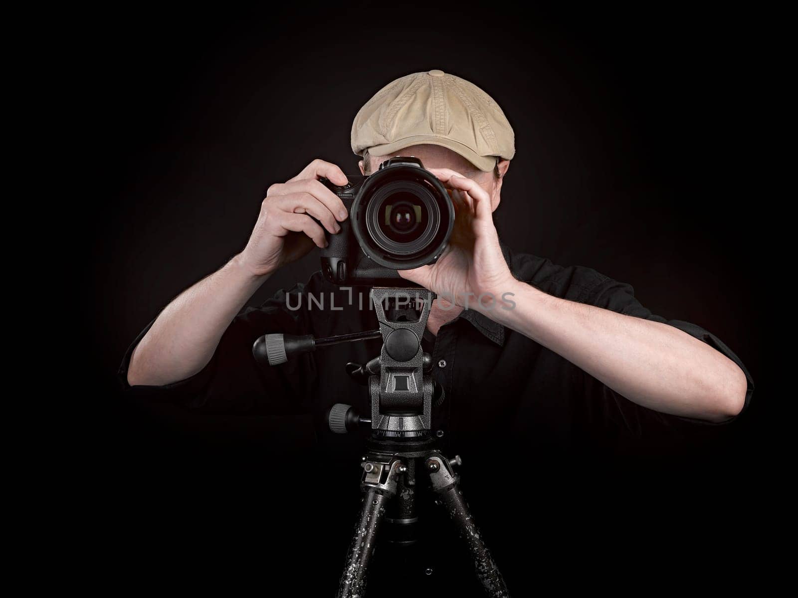 A photographer with a nice camera on black background