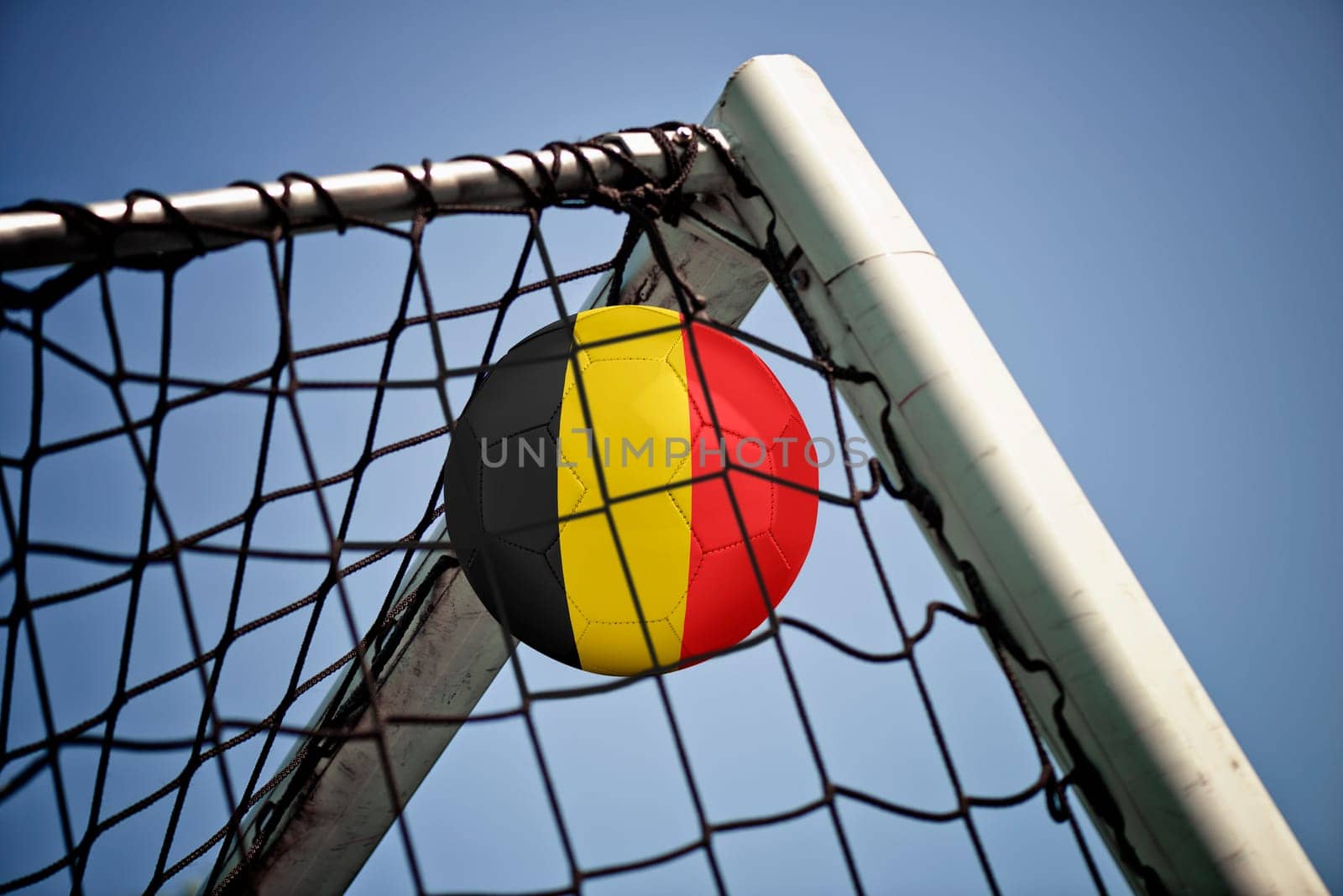 Soccerball in net with the flag of Belgium ready for championship