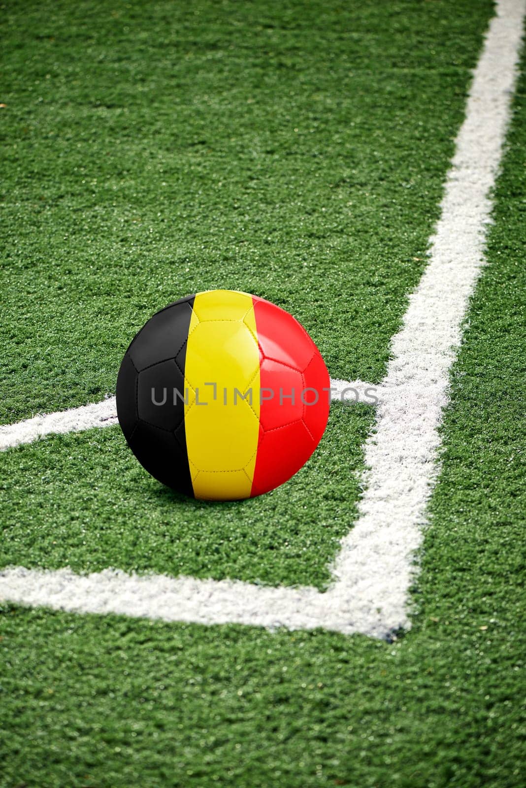 traditional soccer ball on corner from a green soccer field - flag Belgium