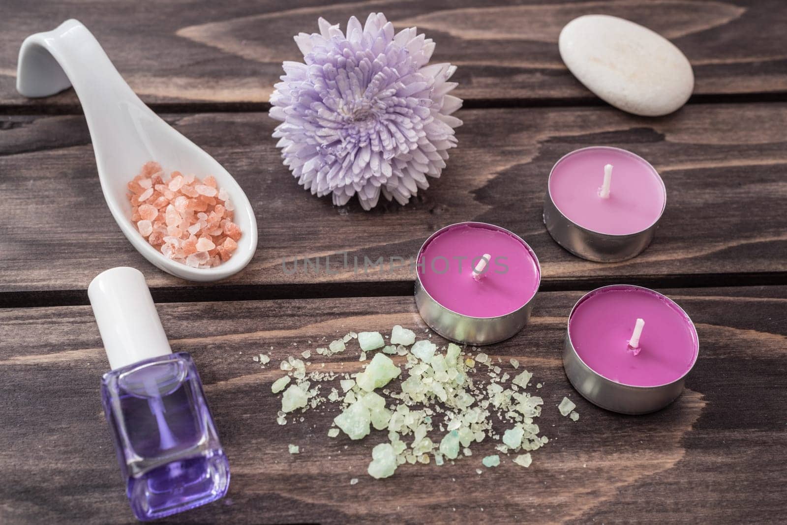 Spa concept. flower,candles, aromatic salt, and bath orange towel  on wooden background.selective focus