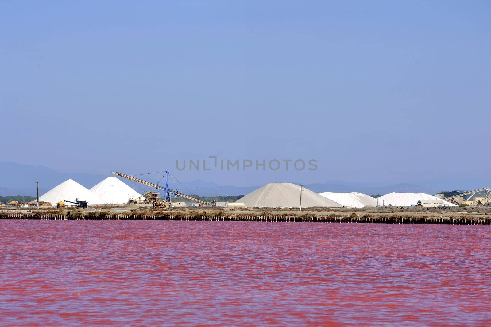 Site operating sea salt saline Aigues-Mortes in the season when a pink algae grow in the water, which gives this beautiful color.