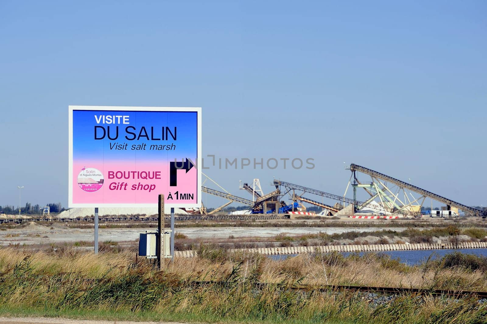 billboard saline Aigues-Mortes in Camargue to announce that tourists can visit the industrial enterprise.