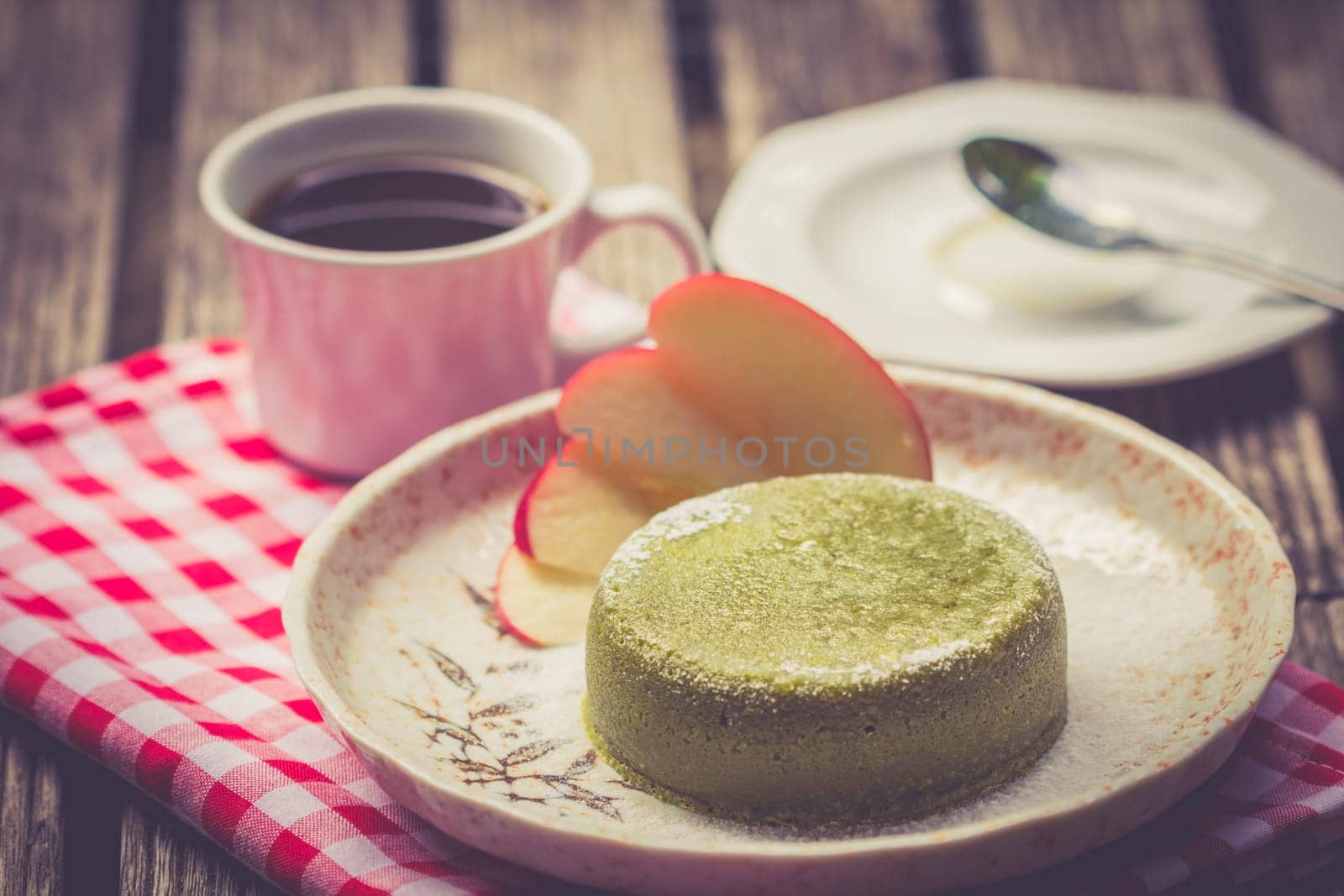 Green tea cake in plate on wooden