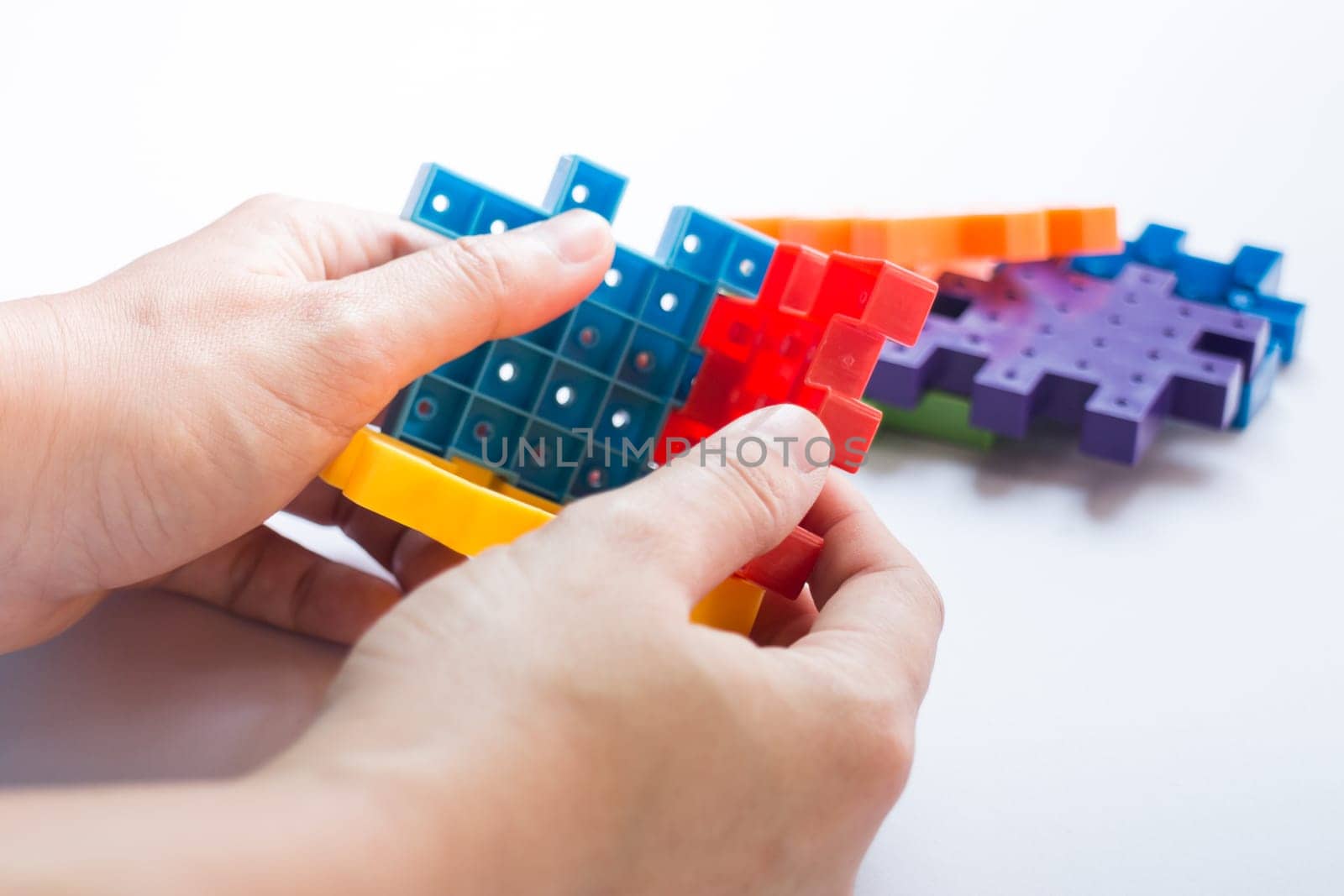 Hand on jigsaw puzzle game, stock photo