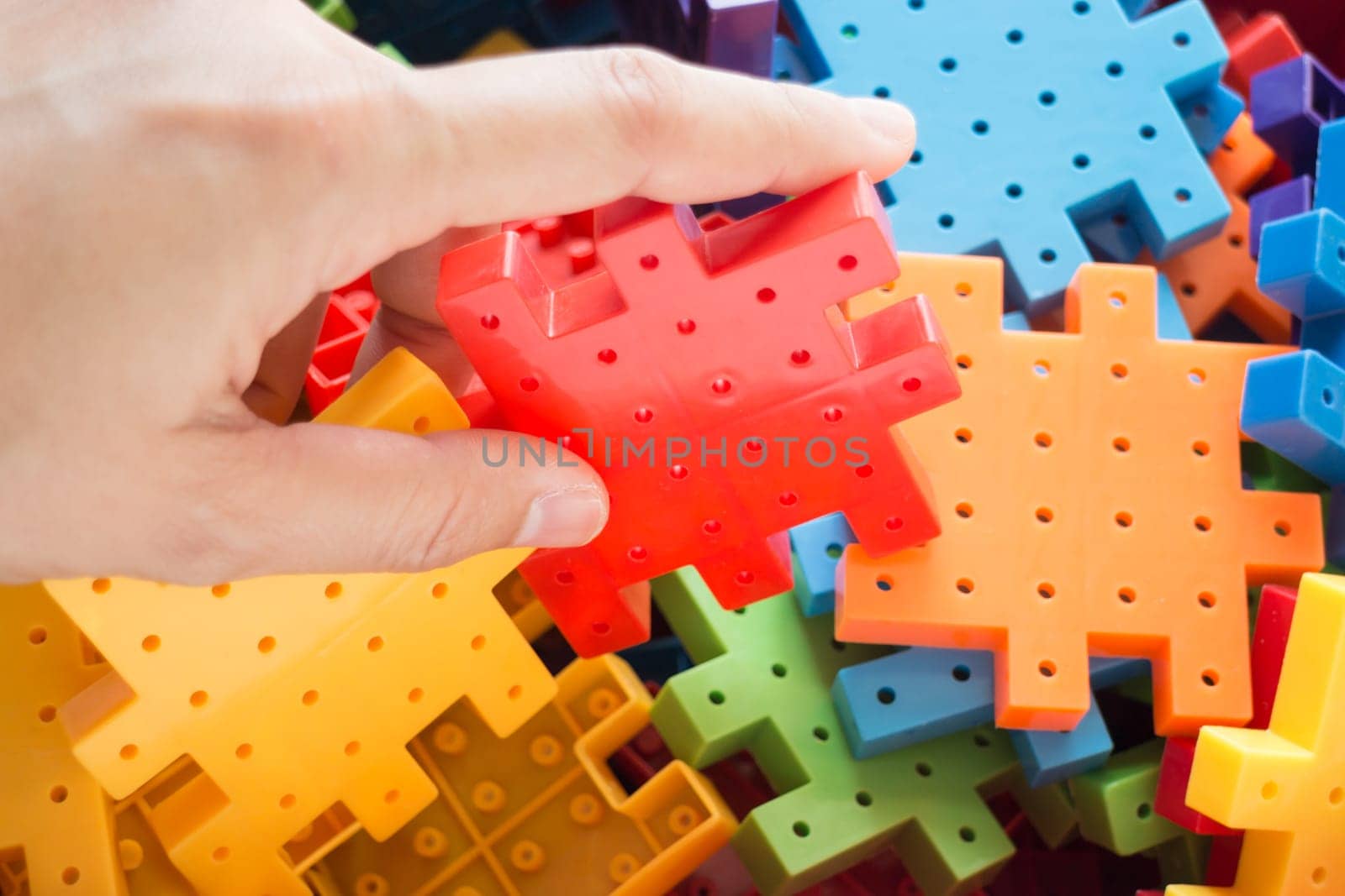 Hand on jigsaw puzzle game, stock photo