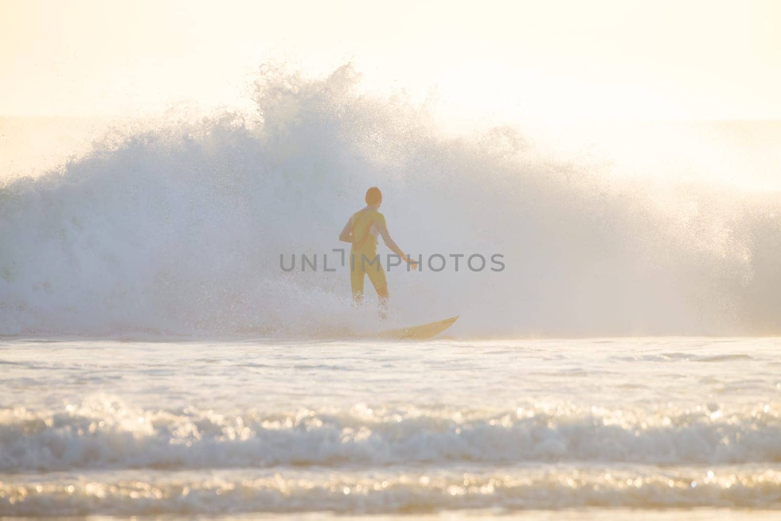 Surfer riding a powerful wave. Panoramic composition.