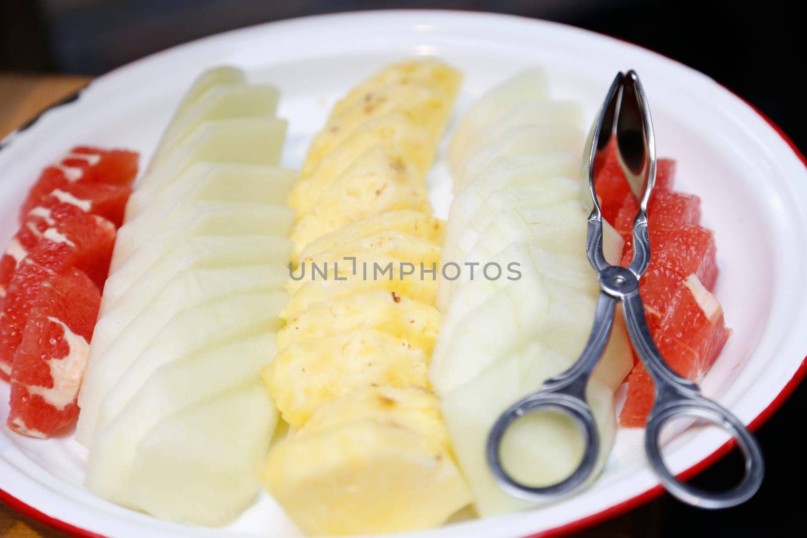 Grapefruit apple pineapple various fruit meal on a plate