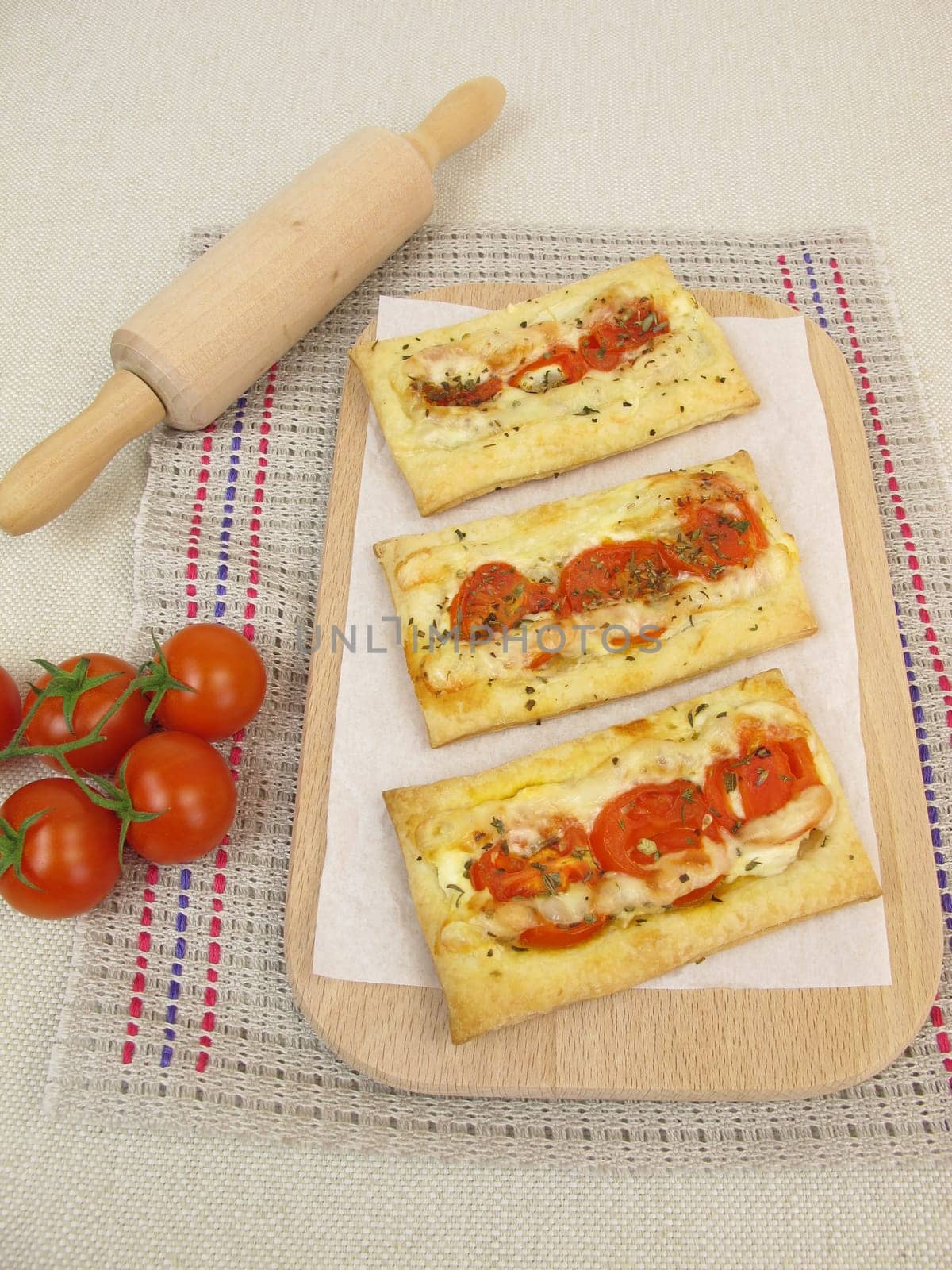Puff pastry pizza with tomatoes and cheese