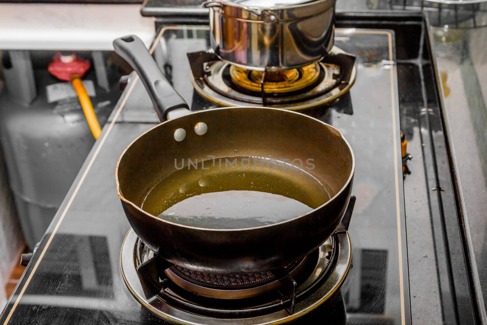 close up oil in pan on gas stove in kitchen