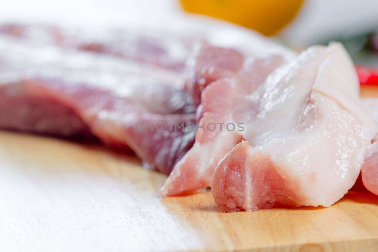 streaky pork with knife on wooden boards