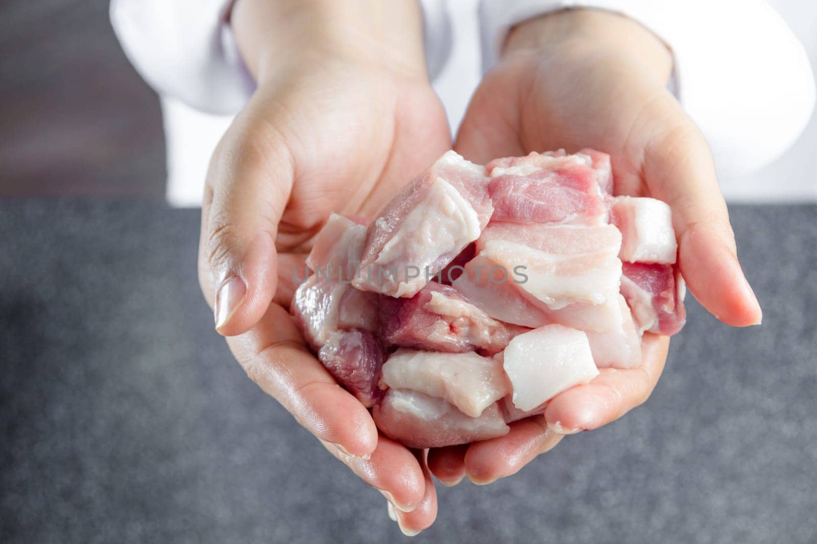 close up chef holding streaky pork
