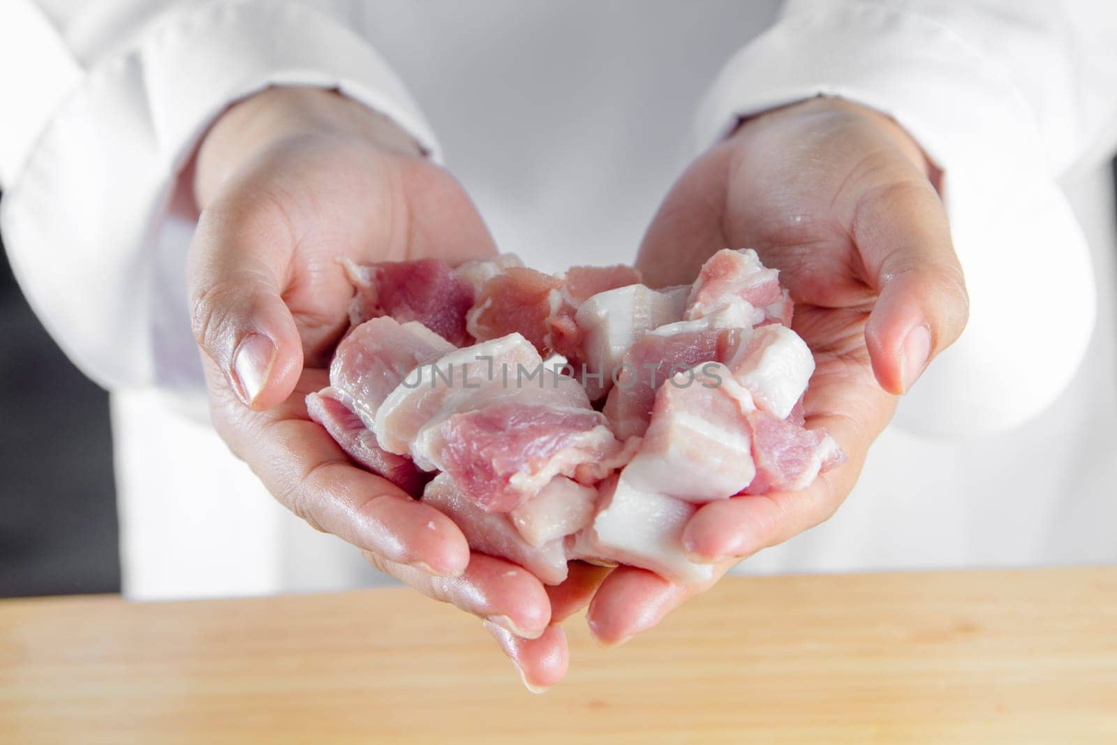 close up chef holding streaky pork
