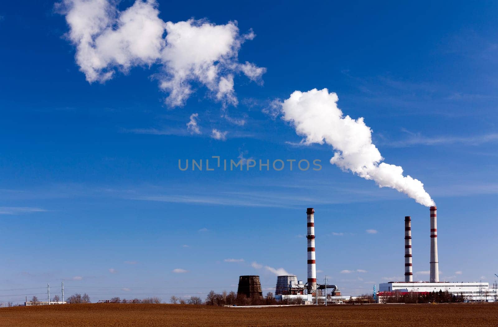 emissions from industrial plants against the blue sky.