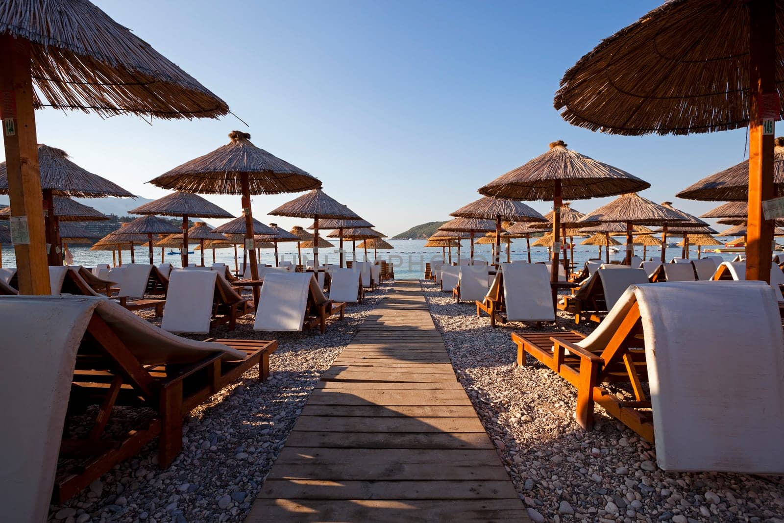 the photographed wooden umbrellas located in the territory of a beach