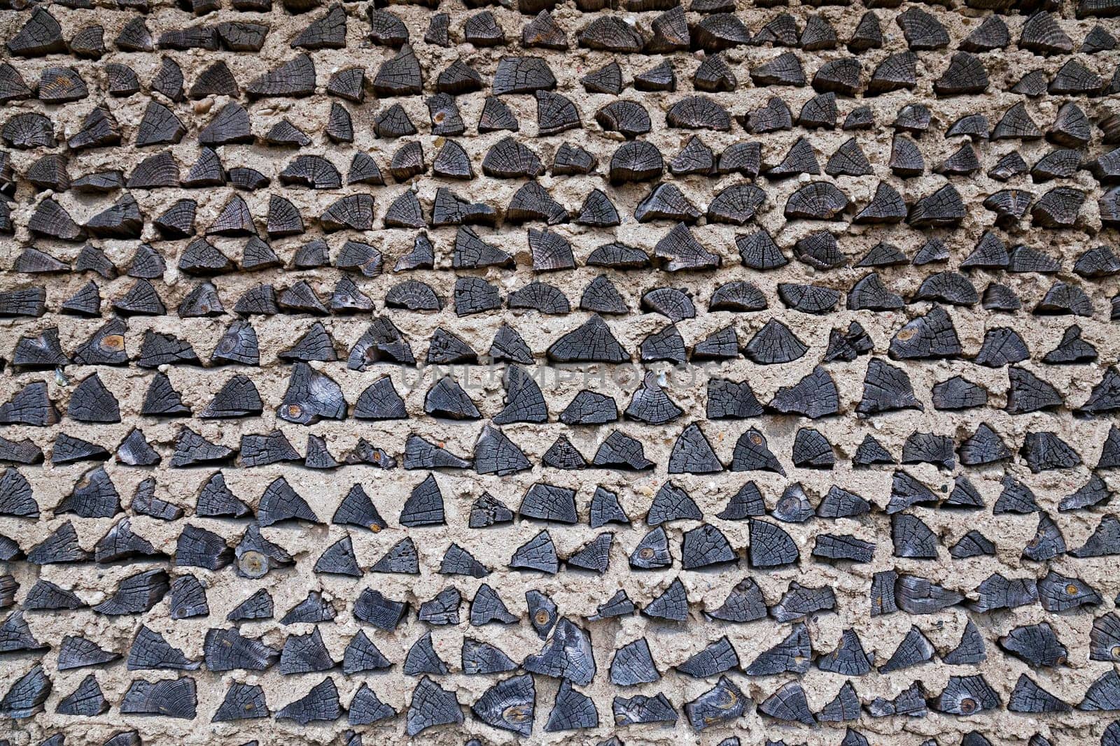 the building wall which is partially made of wooden logs