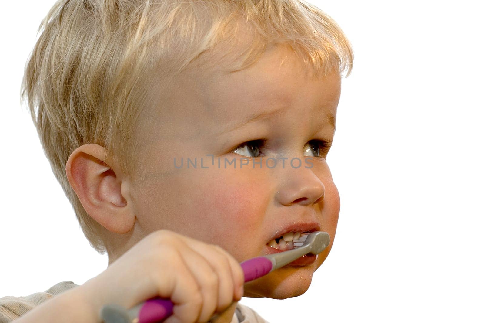 Three year old brushing his teeth