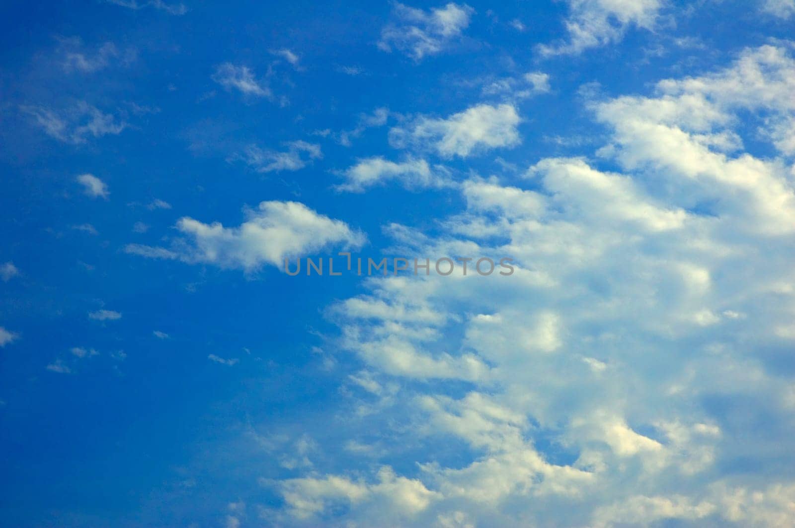 Clouds taking over the bright blue sky.