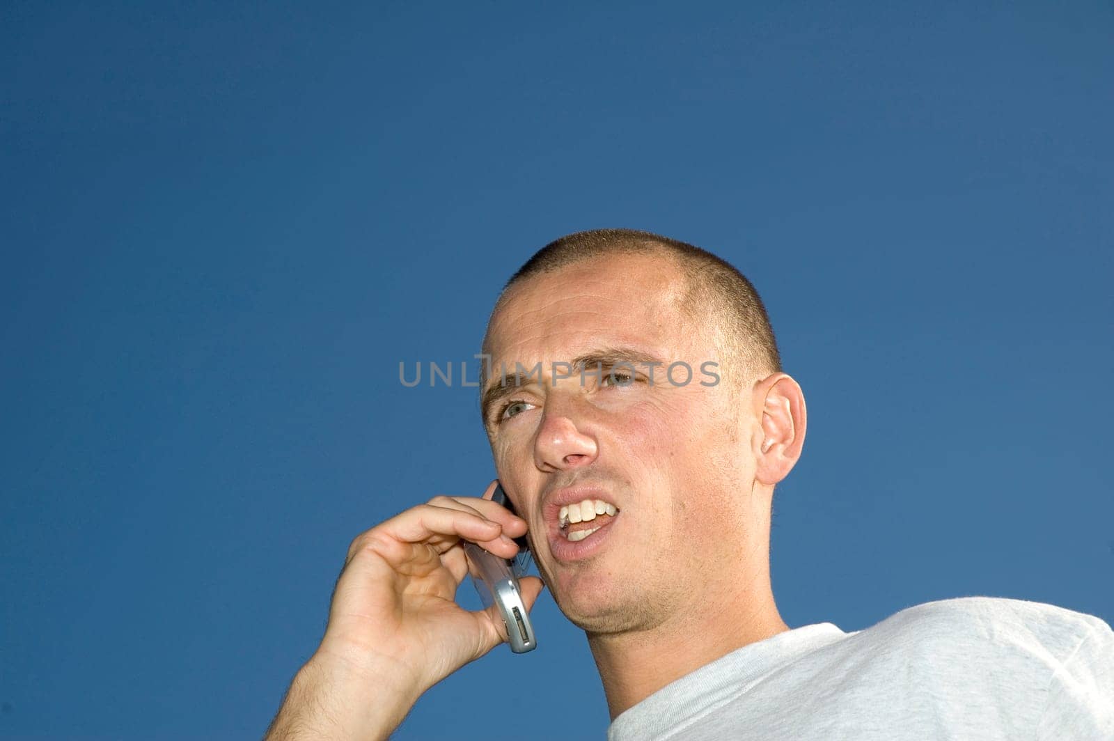 Boy on the phone,looking surprised