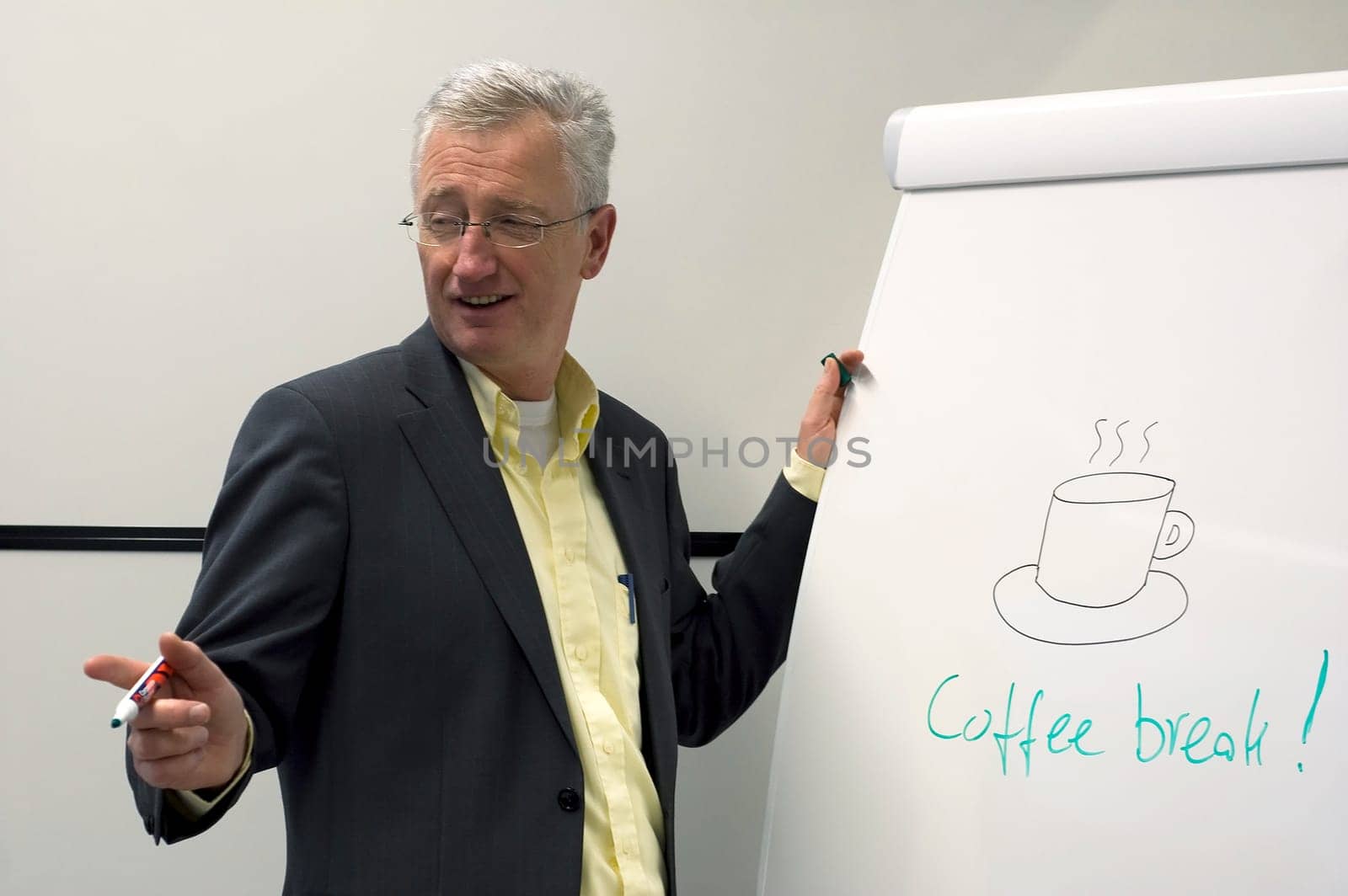 Senior consultant showing his class that a coffee break is coming.