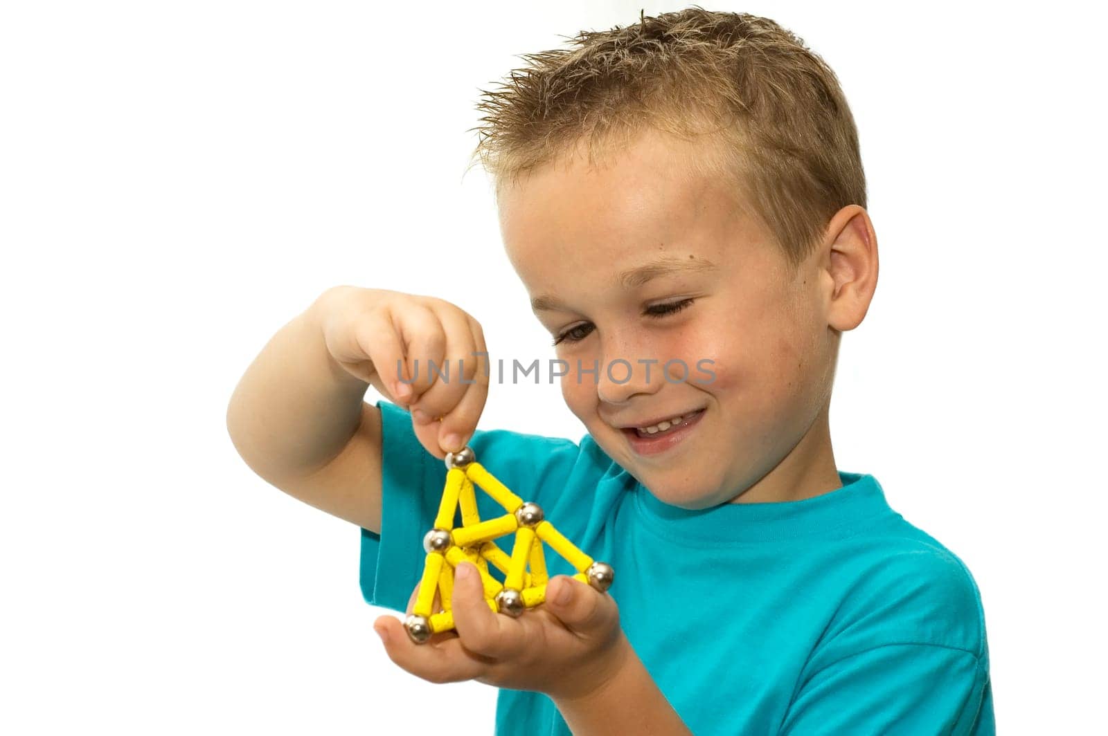 This boy had made something beautiful with his magnets and is very proud.