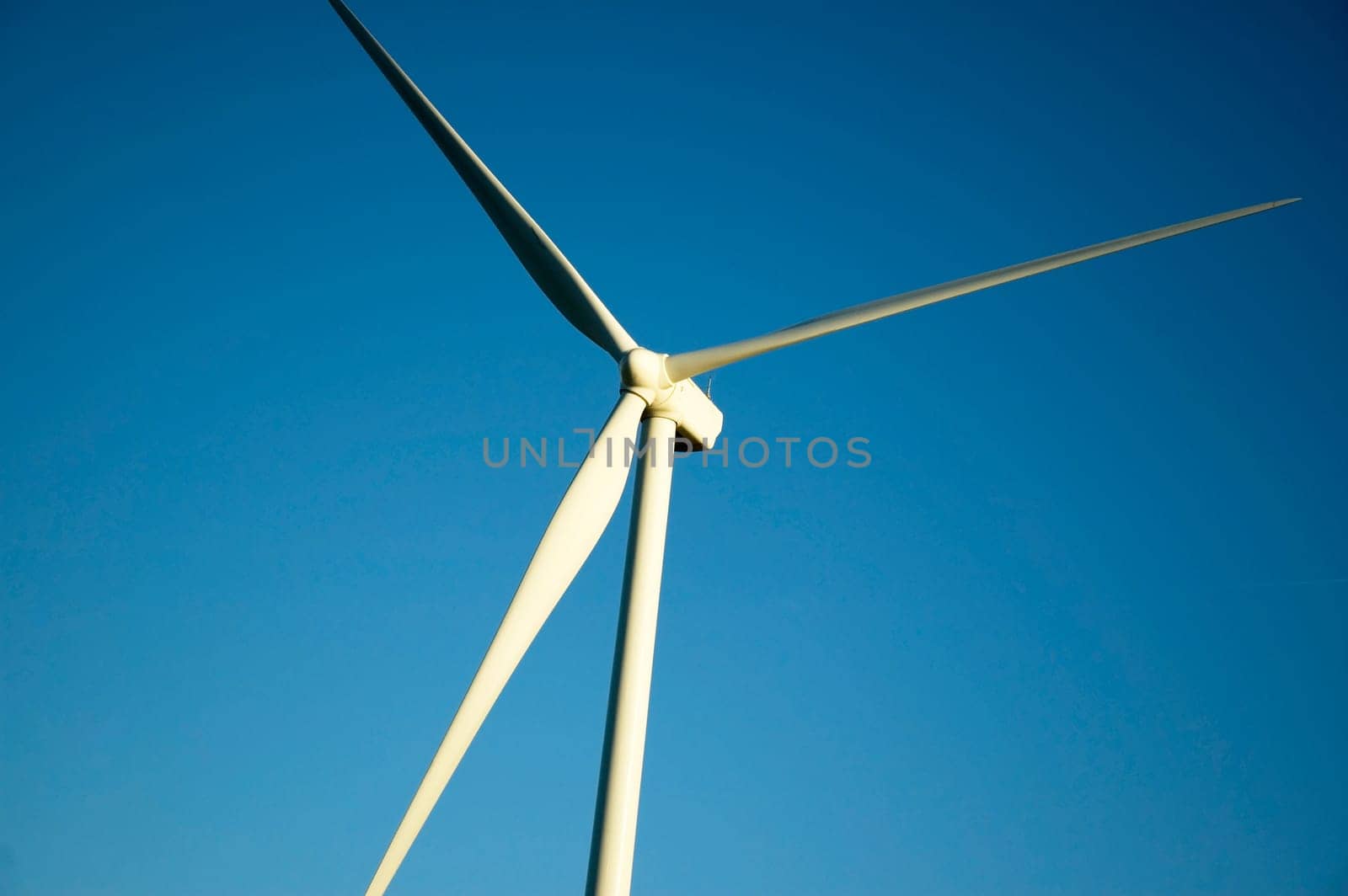 Windmill in front of a clear blue sky.