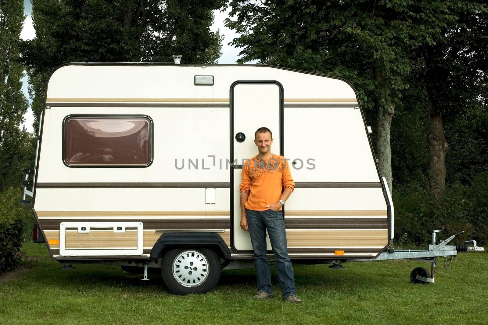 Man standing in front of his caravan