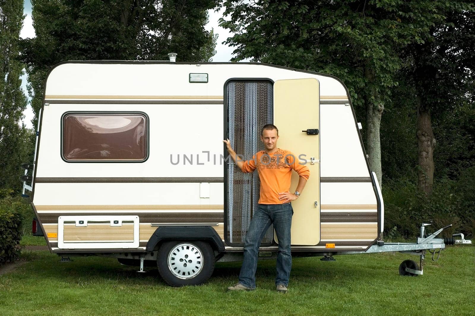 Man standing in front of his caravan