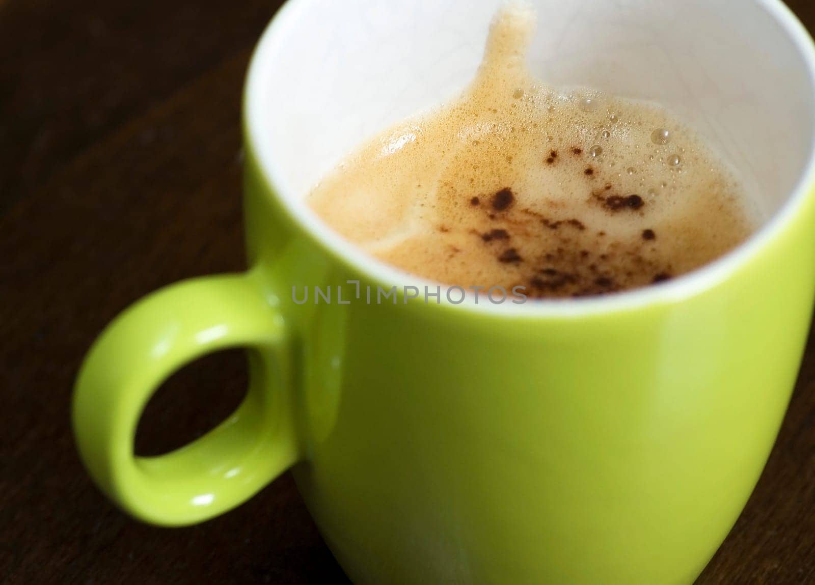 A delicious cup of cappuchino on a table.