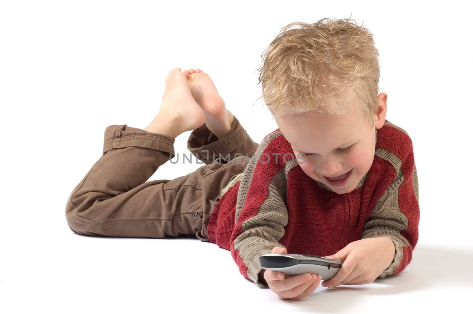 Little boy on the phone, calling his grandpa. Isolated on white.
