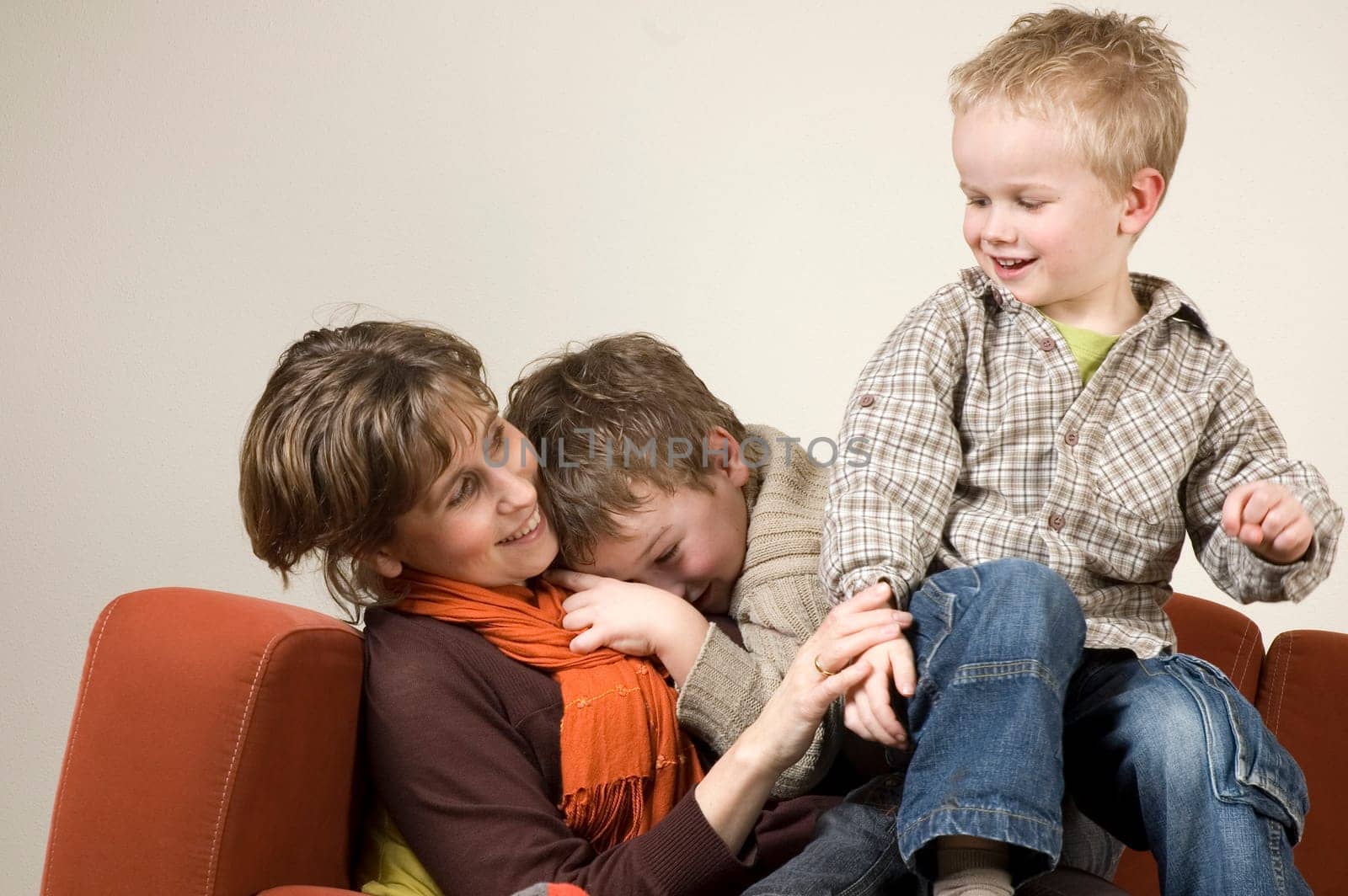 Family playing pranks on a couch.