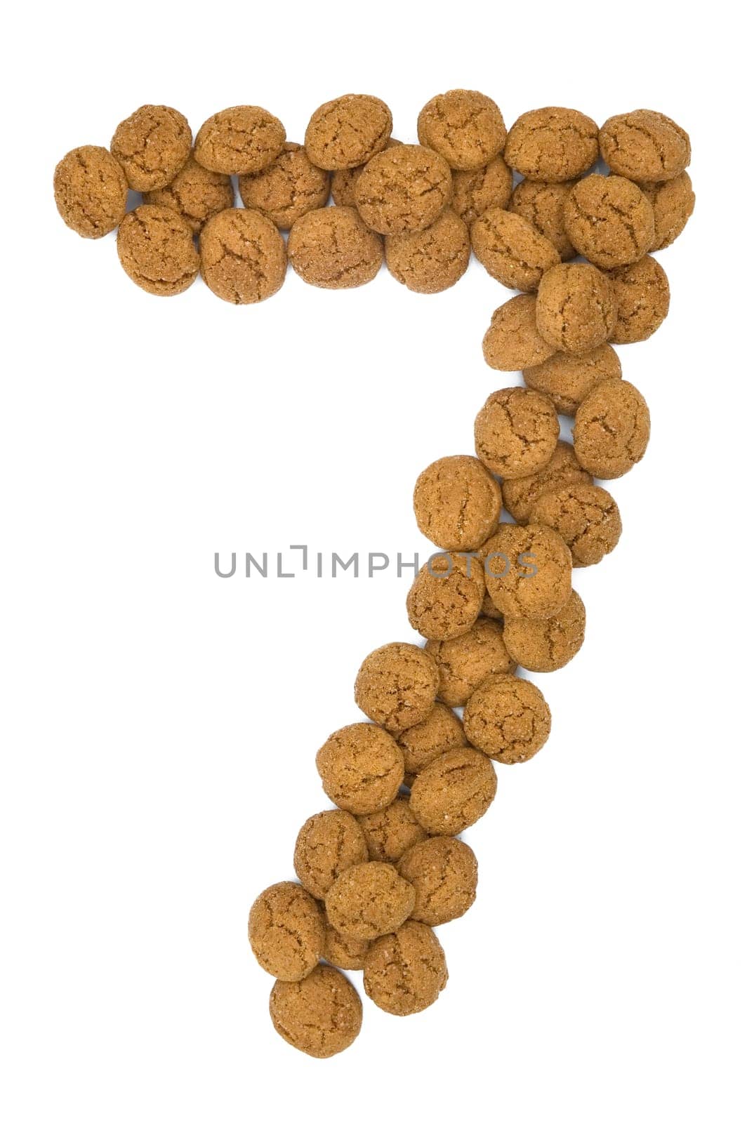 Little ginger nuts in the form of the digit seven. These little ginger nuts are used in Holland for the "Sinterklaas"" party, which is at Dec 5 every year. Sinterklaas is a sort of Santa Claus. In Holland these ginger nuts are called ""pepernoot"". Isolated on white."