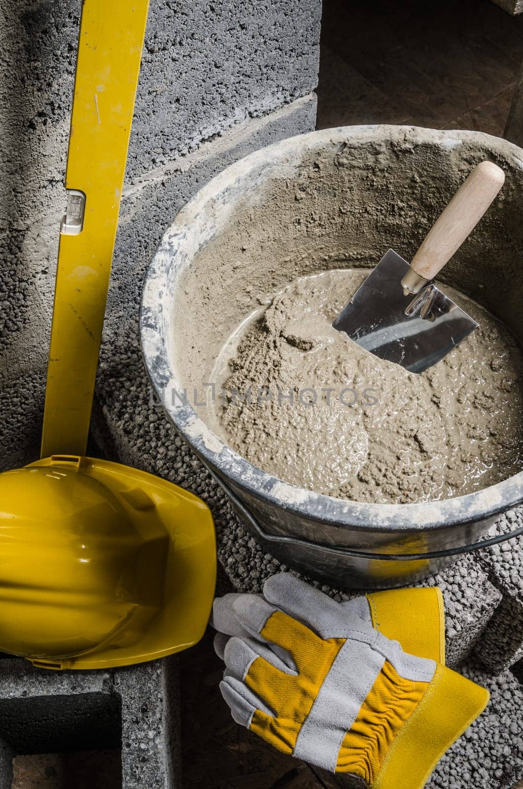 Tools for bricklayer bucket with a solution and a trowel, close-up
