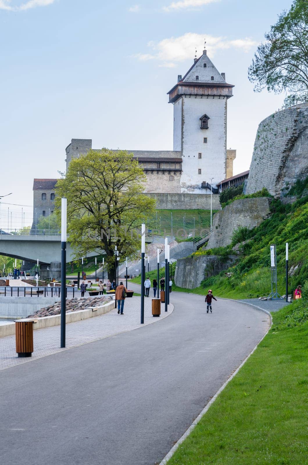 NARVA, ESTONIA - MAY 22 2015: Narva river embankment and a beautiful view of the Ivangorod Fortress and the border of Russia and the European Union