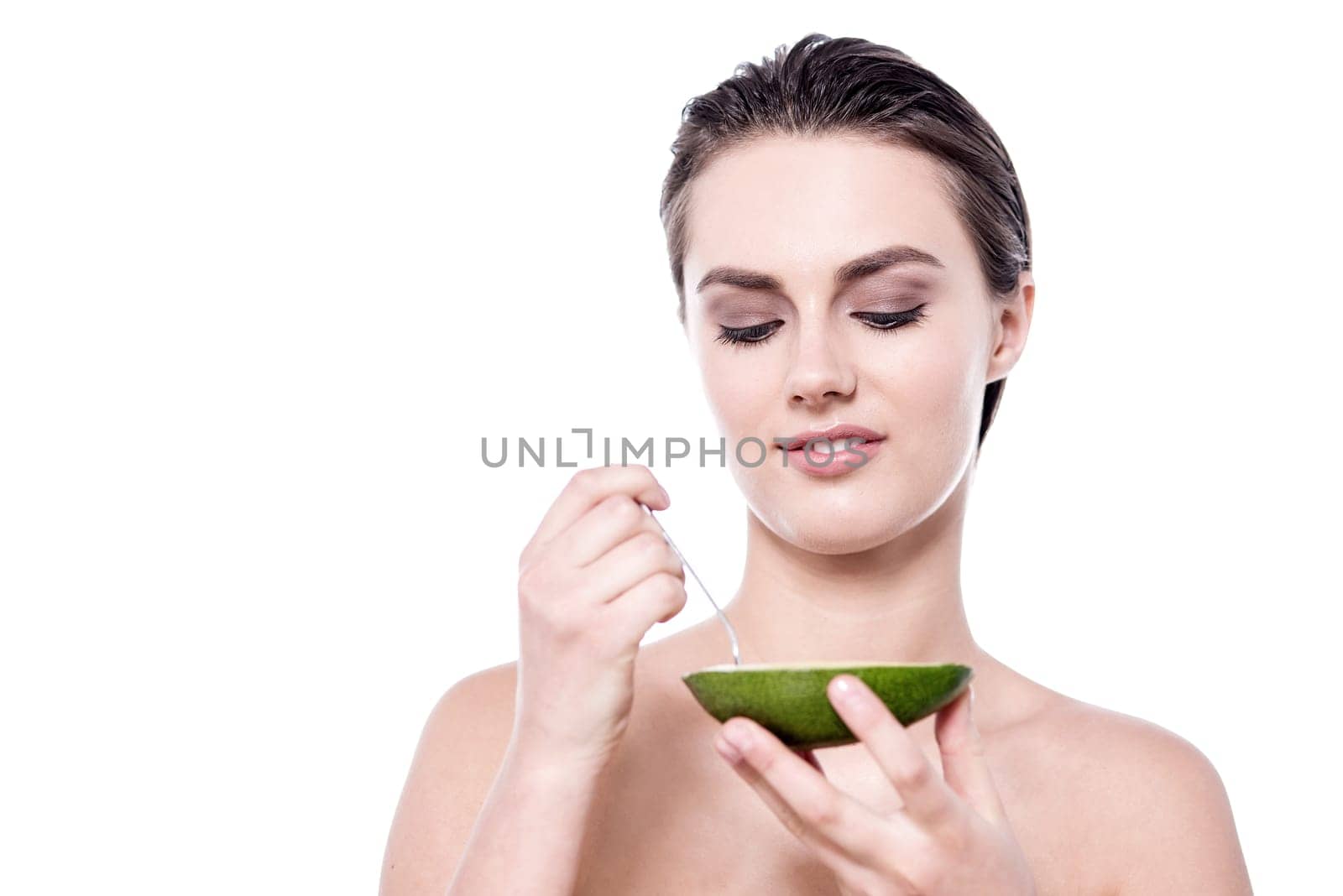Woman ready to eat the fruit using spoon